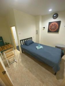 a bedroom with a blue bed and a table at Relax home massage Ao nang 1 in Ao Nang 