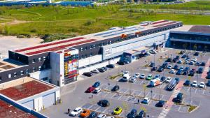 a large building with cars parked in a parking lot at McDreams Hotel Essen in Essen