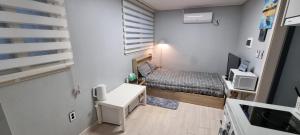 a small room with a bed and a desk at Bombay Residence SNU Nakseongdae Station in Seoul