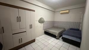 a small room with a bed and cabinets in it at Casa na Praia de Iracema R&S in Fortaleza