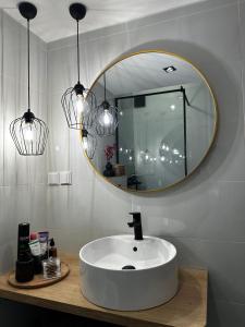 a bathroom with a white sink and a mirror at Panthera-urban-studio in Xanthi