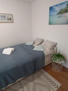 a bedroom with a bed and a painting on the wall at Holiday House with scenic Apartment in Ptuj