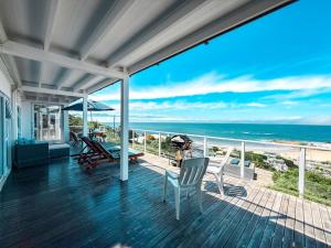 a house with a deck with a view of the ocean at Harker Street Sea Facing Studio in Plettenberg Bay