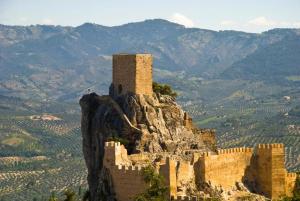 a castle on top of a mountain with mountains at La lobera in Arroyo Frio