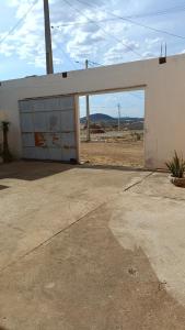 a white building with a large garage door at Pousada Vôo Livre in Serra Talhada