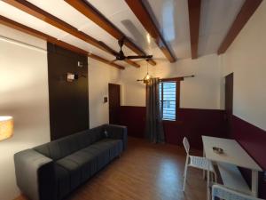 a living room with a couch and a table at Seasonyard Homestead in Dibrugarh
