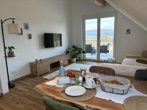 a living room with a table with food on it at Ferien am Winkelhof in Deggenhausertal
