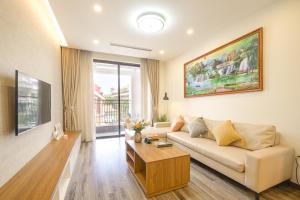 a living room with a couch and a table at Duc Hoang Residence & Hotel West Lake in Hanoi