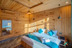 Una cama o camas en una habitación de Zostel Homes Gadagushaini, Jibhi