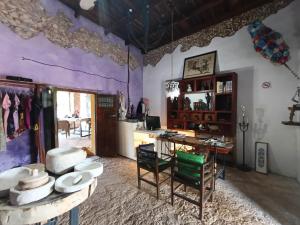 a room with a desk and a table with hats at Hotel Tihosuco Colonial in Tihosuco