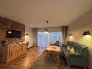 TV a/nebo společenská místnost v ubytování Ferienwohnungen Landhaus Haake