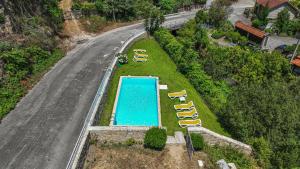 an overhead view of a swimming pool with yellow chairs at Gerês Cascatas Residence in Geres