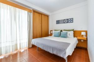 a bedroom with a bed and a large window at Gerês Cascatas Residence in Geres +39 photos