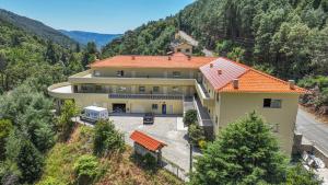 an aerial view of a house in the mountains at Gerês Cascatas Residence in Geres