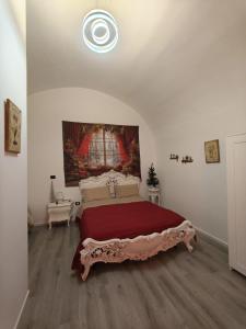 a bedroom with a large bed and a painting on the wall at Oasi di san Benedetto in Castellaneta