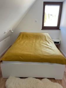 En eller flere senge i et værelse på Domek Rodzinny Martynka