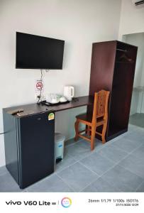 a desk with a computer and a chair in a room at Naranta House in Ko Raeng