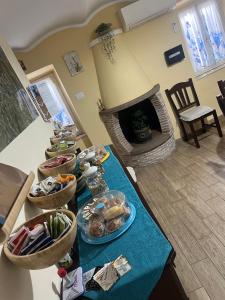 a table with bowls of food on it with a fireplace at Il Tronchetto in Monte Libretti