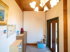 a room with a desk and a chandelier at Beautiful Nasu, the center of Nasu, Up to 12 people, 3 bedrooms, BBQ on the deck, night karaoke in Nasu +40 photos