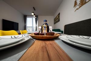 a bottle of syrup sitting on a table with plates at Apartmán 110 Vila Zuberec in Zuberec +46 photos