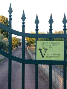 a sign on the gate of a fence at TABERNA ROMANA VILLA OCA b&b in Velletri