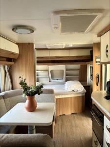 a small room with a bed and a table at Skrea Camping in Falkenberg