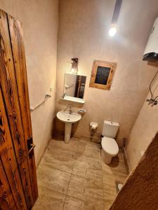 a bathroom with a toilet and a sink at El-Beit in Siwa +41 photos