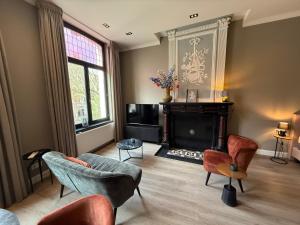 a living room with chairs and a fireplace at Maastricht Suites - City Studio A in Maastricht