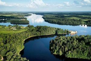 an aerial view of a large river with trees at Ragnar Glamp Koknese Forest in Koknese +12 photos