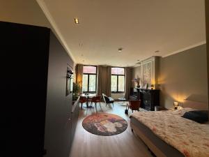a bedroom with a bed and a living room at Maastricht Suites - City Studio A in Maastricht