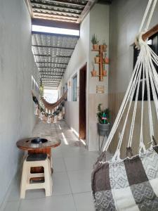 a room with a hammock and a hallway at Casa de veraneio - FA Beach in Conde +15 photos