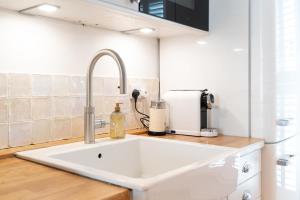 een keuken met een witte wastafel en een aanrecht bij 70 Trefusis in Flushing +72 foto's