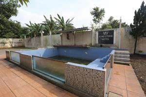 a pool of water on a patio next to a fence at King Stone Hotel By ARBA in Kranggan-wetan Satu