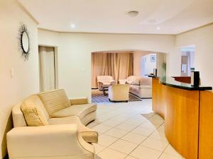 a living room with a couch and a table at Siena Sun Celebration House Party friendly noise tolerant in Midrand