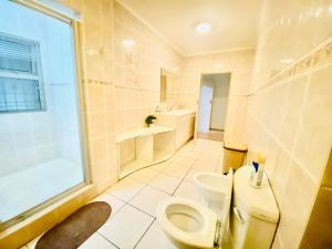 a bathroom with a toilet and a sink at Siena Sun Celebration House Party friendly noise tolerant in Midrand +40 photos