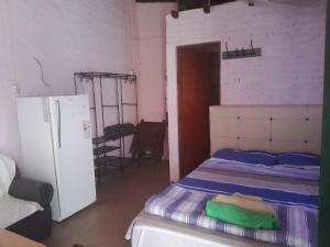 Ένα ή περισσότερα κρεβάτια σε δωμάτιο στο El Rincón del Capibara Alojamientos