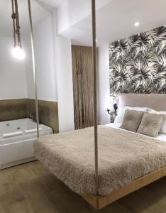 a bedroom with a swinging bed and a bath tub at Idromassaggio Room in Catania