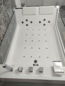 a white boat in a glass display case at Idromassaggio Room in Catania +9 photos