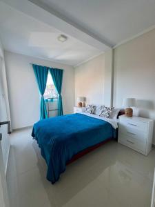 Novi BanovciにあるPrenočište Dunavの青いベッドと窓のある寝室