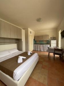a bedroom with a large bed with towels on it at Villa Tony - Baia Verde Only Teenagers in Baia Verde +41 photos