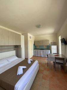 a bedroom with a large bed with towels on it at Villa Tony - Baia Verde Only Teenagers in Baia Verde
