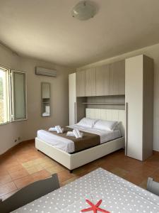 a bedroom with a large bed in a room at Villa Tony - Baia Verde Only Teenagers in Baia Verde