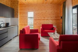 a kitchen and living room with red chairs and a table at Meronts in Yeghipatrush