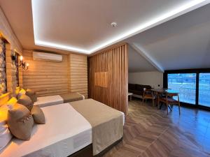 a hotel room with a bed and a dining room at Gumus Palace Hotel in Istanbul