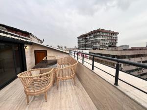 a balcony with a table and chairs on a roof at Gumus Palace Hotel in Istanbul
