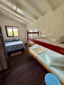 a room with two bunk beds in a house at Residencial Solar del Nieto in Garopaba +49 photos