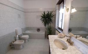 a bathroom with a sink and a toilet and a tub at Agriturismo Villa Bordone in Villafranca dʼAsti