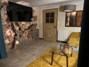 a living room with a large painting on the wall at L'atelier au jardin in Strasbourg