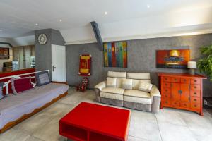 a living room with a bed and a couch at Le Flamboyant 309, magnifique appartement avec piscine in Saint-Gilles les Bains +18 photos