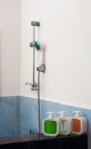 a bathroom with a shower with two toasters on a counter at COCOONING HOME # Centre-Ville # Confort # Charmant # マダガスカルのゲストハウス in Antananarivo